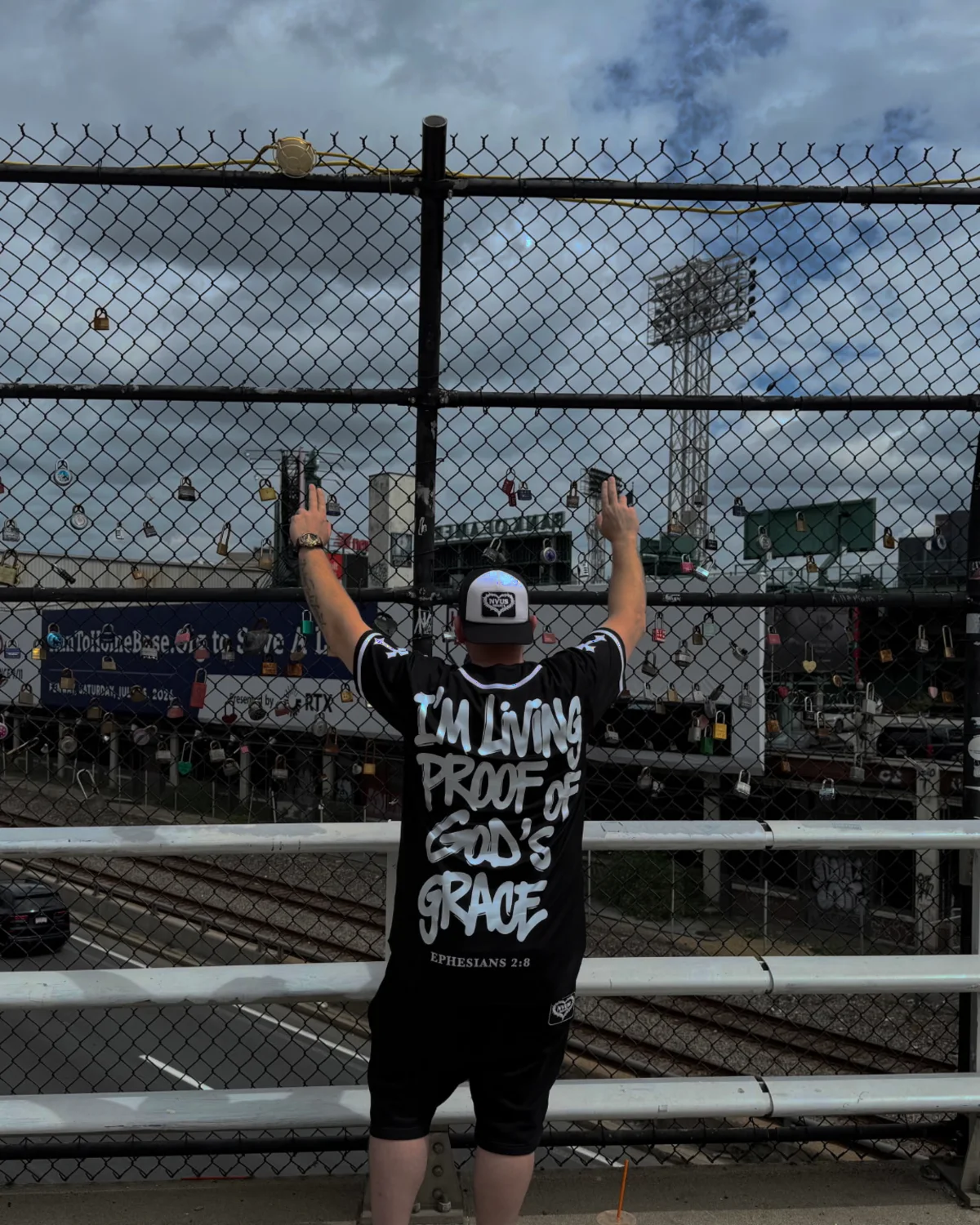 Keith, founder of NVUS Hearts, on the bridge over the Mass Pike in Boston, wearing the Living Proof tee
